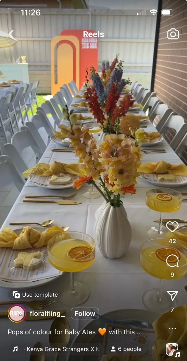 A group of people at a baby shower laughing and writing in a guest book