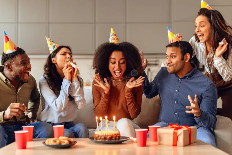 A group of people laughing together at a birthday party
