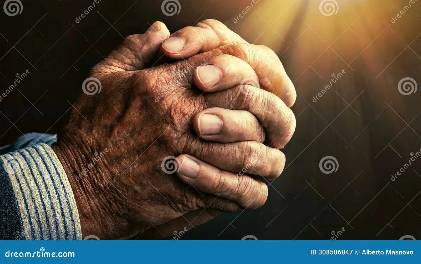 Close up of hands folded in prayer holding a wooden cross