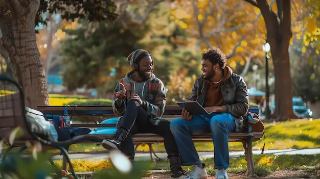 Two friends sitting together in a park, talking calmly