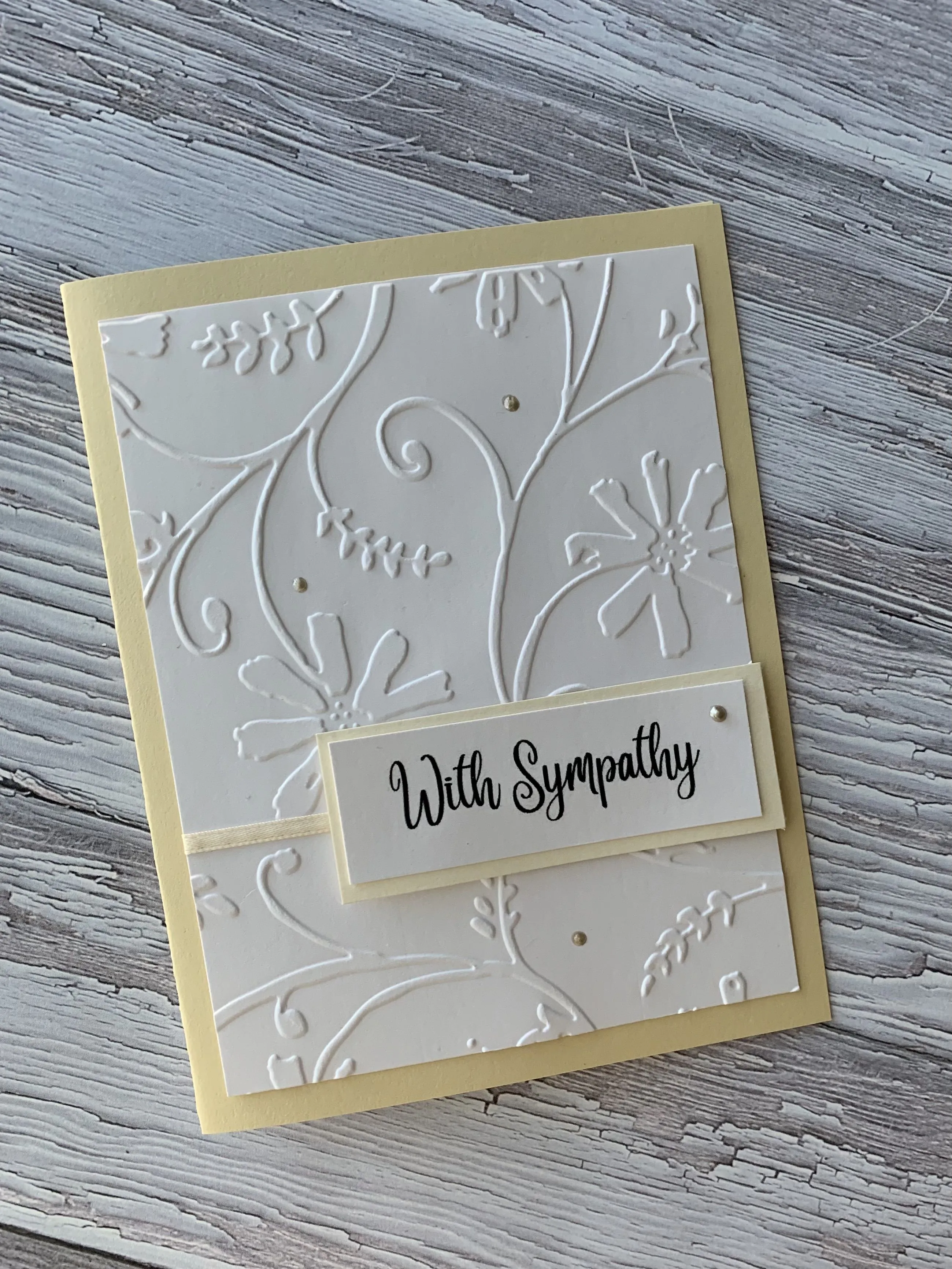 A handwritten sympathy card on a wooden table