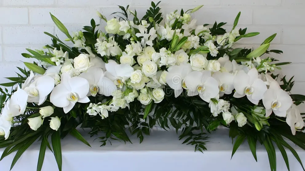 Formal floral arrangement with a gold-bordered sympathy card