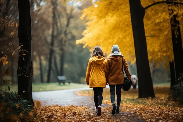 Two friends walking together in a park, engaging in a quiet conversation