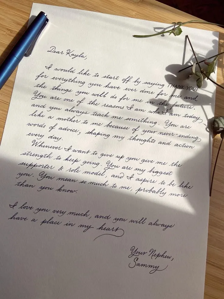 Close up of a person writing a thoughtful sympathy message on a card.